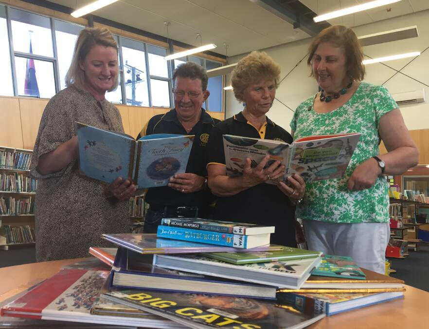 NEW BOOKS: Looking at the book donation is East Tamar Primary School principal Karen Hay, West Tamar Rotary Club members David Annear and Kathryn Darlow, with teacher in the library Anne Donnelly. Picture: Holly Monery