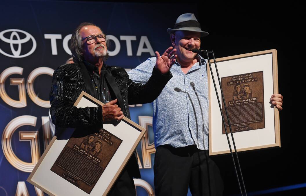 HONOURED: The Bushwackers' Dobe Newton and Roger Corbett receiving their Australasian Country Music Roll of Renown awards at the Golden Guitars on Saturday night. Picture: Gareth Gardner