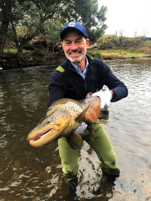 GET FISHING: Minister for Primary Industries and Water releases one of the five $10,000 trout into Tasmanian waters. Picture: Supplied 