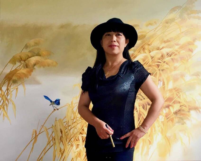 PAINTER: Qing Yang in front of her work, Blue Wrens in Conversation. Picture: Supplied