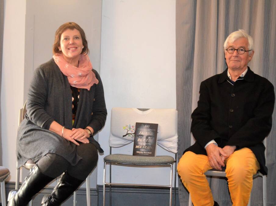 Tamar Valley Writers Festival director Mary Machen, the empty chair with Behrouz Boochani's book No Friend but the Mountains, and QC Julian Burnside. 