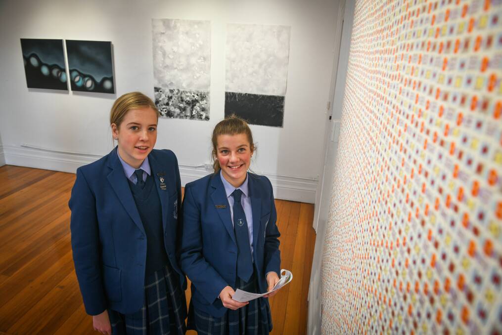 EXPOSURE: Launceston Church Grammar students Poppy Eastaugh, 16, and Emily Fryett, 15, check out the Paint_19 exhibition. Picture: Paul Scambler