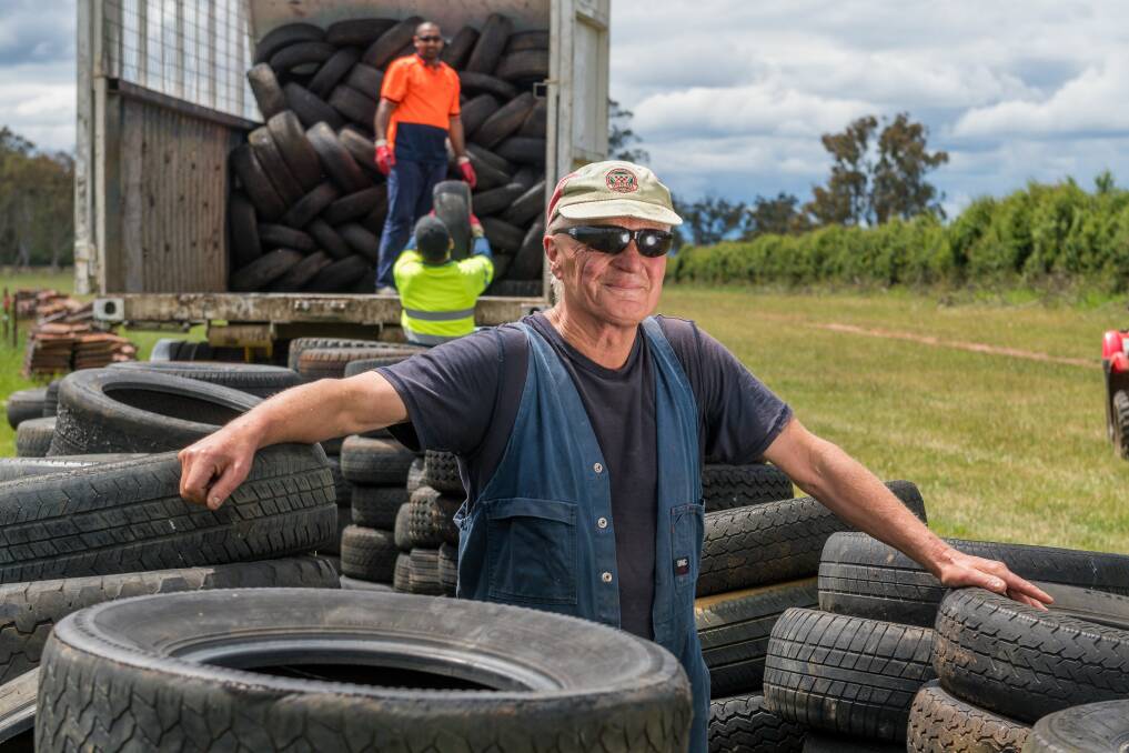 READY TO ROLL: Farmer Bill Cox with his tyre stockpile, as Kelvin and Rana Singh load tyres onto a truck to be removed and reused. Picture: Phillip Biggs 