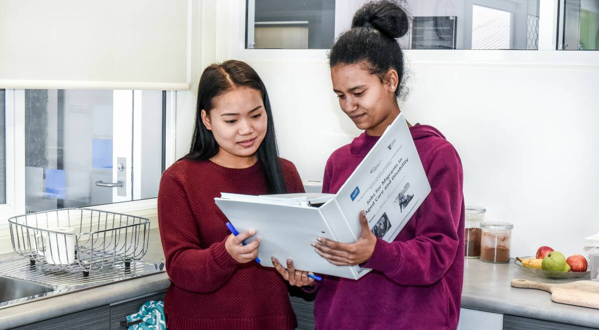 STUDYING: Participants in the Jobs for Migrants in Aged Care and Disability program Cangmai Tahaih and Nuha Ali. 
Picture: Neil Richardson