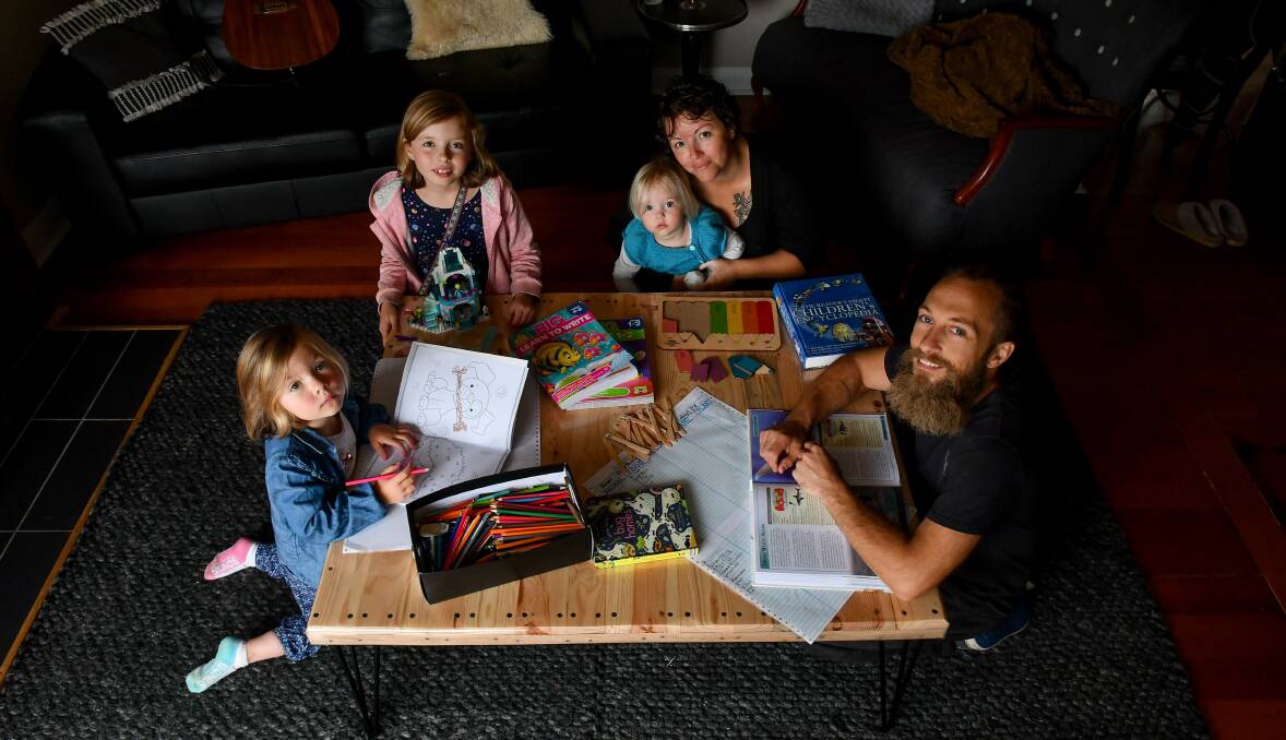 Adam and Jess Maloney homeschooling Fleur, 5, Uma, 8, and Ottilie, 2. Pictures: Scott Gelston