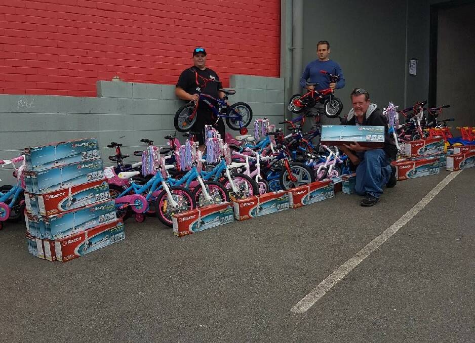 GENEROUS: Matthew Richards with Mitch Loyd and Peter Richards transporting the 120 bikes to the Launceston Benevolent Society. Picture: Supplied