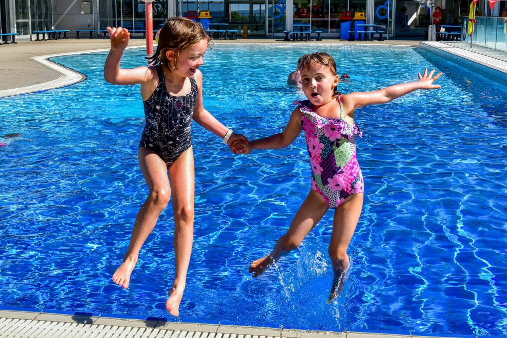 COOL DOWN: Genevieve Murphy, 8, and Willow Johnston, 5, having a splash at Launceston Aquatic Centre. Picture:  Neil Richardson