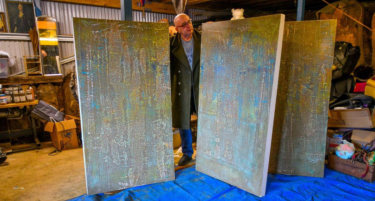 ABSTRACT: Launceston artist Chris Flood with the three panels of his painting, Come Close. Picture: Scott Gelston 