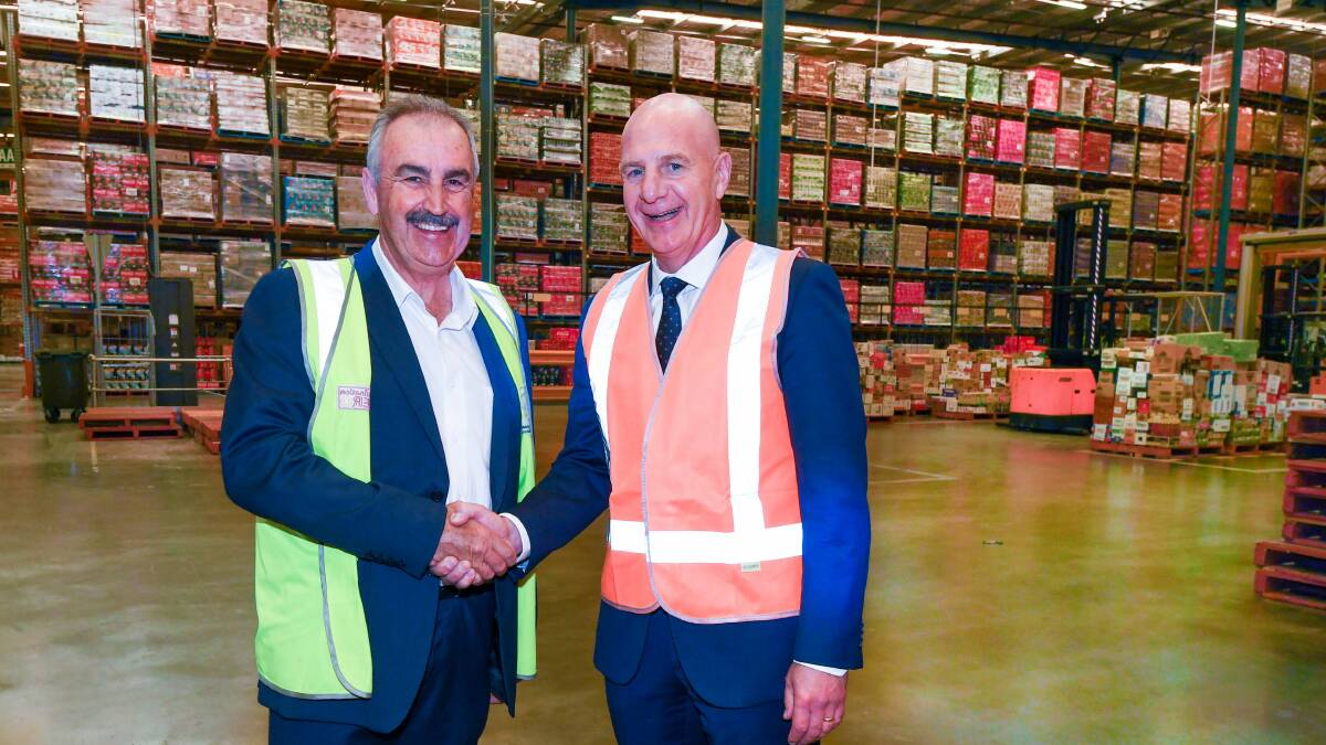 BIG BUILDING: Tasmanian Regional Distribution Centre general manager David Lanham is congratulated by Premier Peter Gutwein. Picture: Neil Richardson