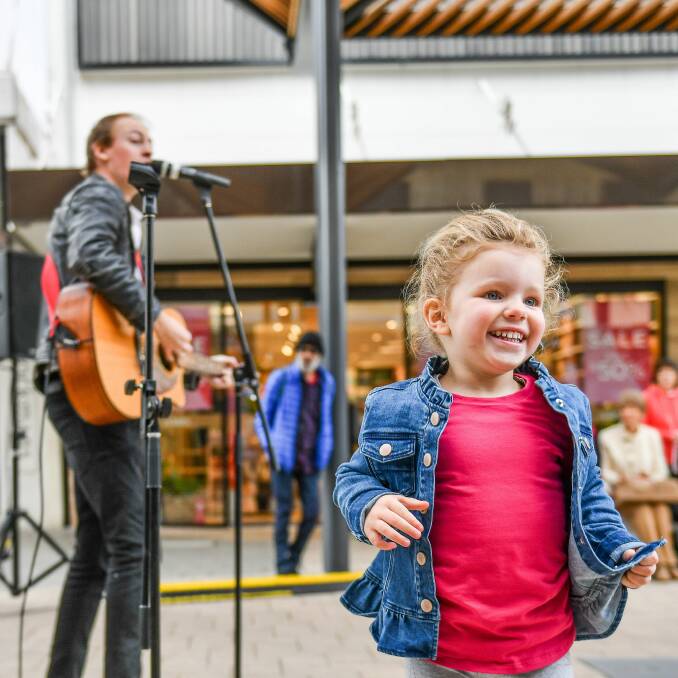 HAPPY FACES: Eden Richardson, 3, dances to performer Scott Haigh in the Brisbane Street Mall. Picture: Scott Gelston