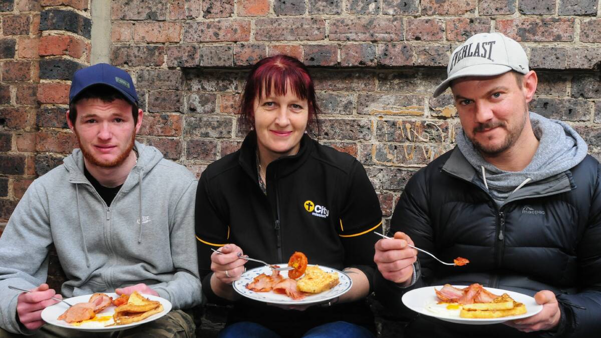 Jezz Farrow, Robyn Nicholas and Ricki Baxter dig in at the City Mission Hoodies for Homelessness breakfast. Picture: Neil Richardson 