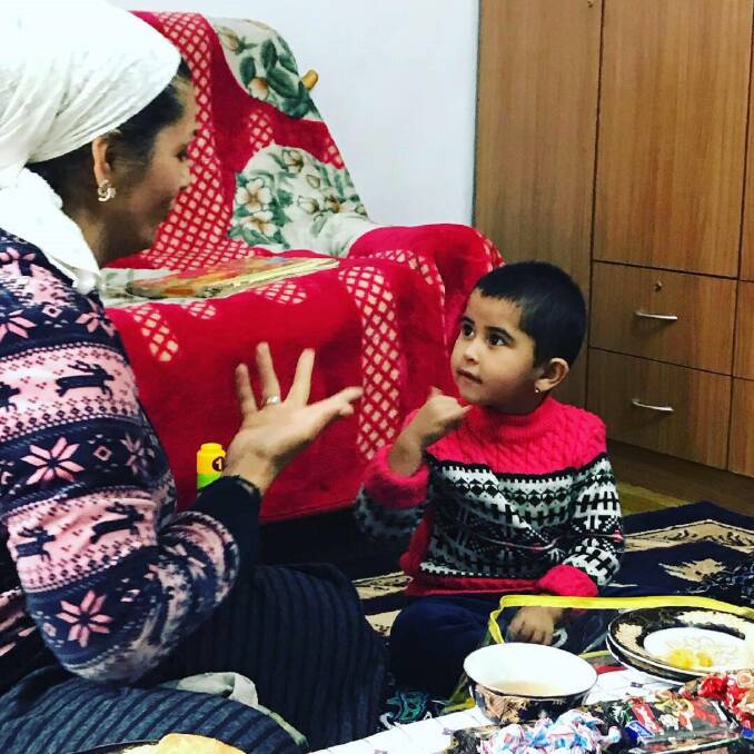 LEARNING LANGUAGE: A tutor with Deaf Children of Central Asia teaches sign language to a child. Picture: Supplied 