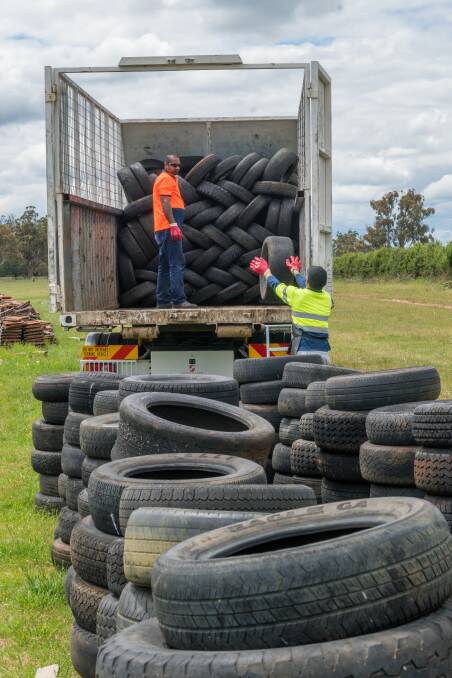 ON THE ROAD: Kelvin and Rana Singh load tyres onto a truck. Picture: Phillip Biggs