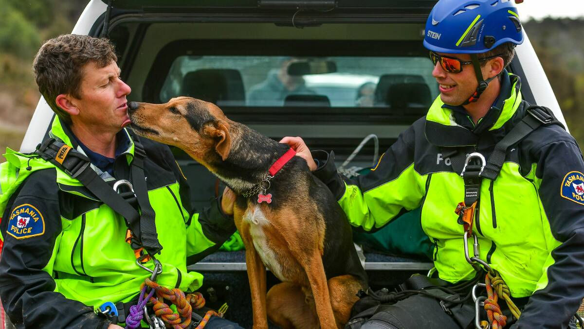 Ralphie (middle) thanks Senior Constables Simon Triffitt and Leighton Riggall for rescuing him from a cliff face. Picture: Scott Gelston