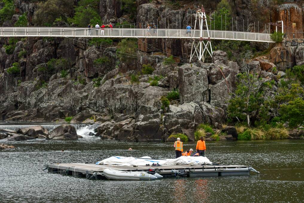 MAN DOWN: Mona Foma is working to repair the art installation in First Basin, Cataract Gorge. Picture: Scott Gelston 