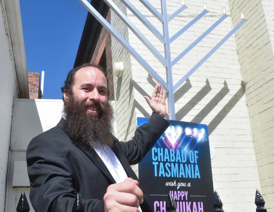 JEWISH CELEBRATION: Rabbi Yochanan Gordon with the 3.5 metre Menorah to be placed in Brisbane Street Mall. Picture: Neil Richardson