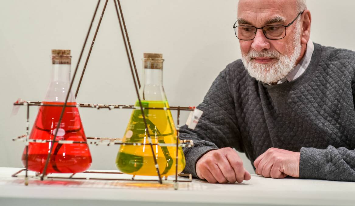 CHEMISTRY: Exhibition curator and University of Tasmania chemist Murray Frith with old solvent bottle carriers. Picture: Neil Richardson