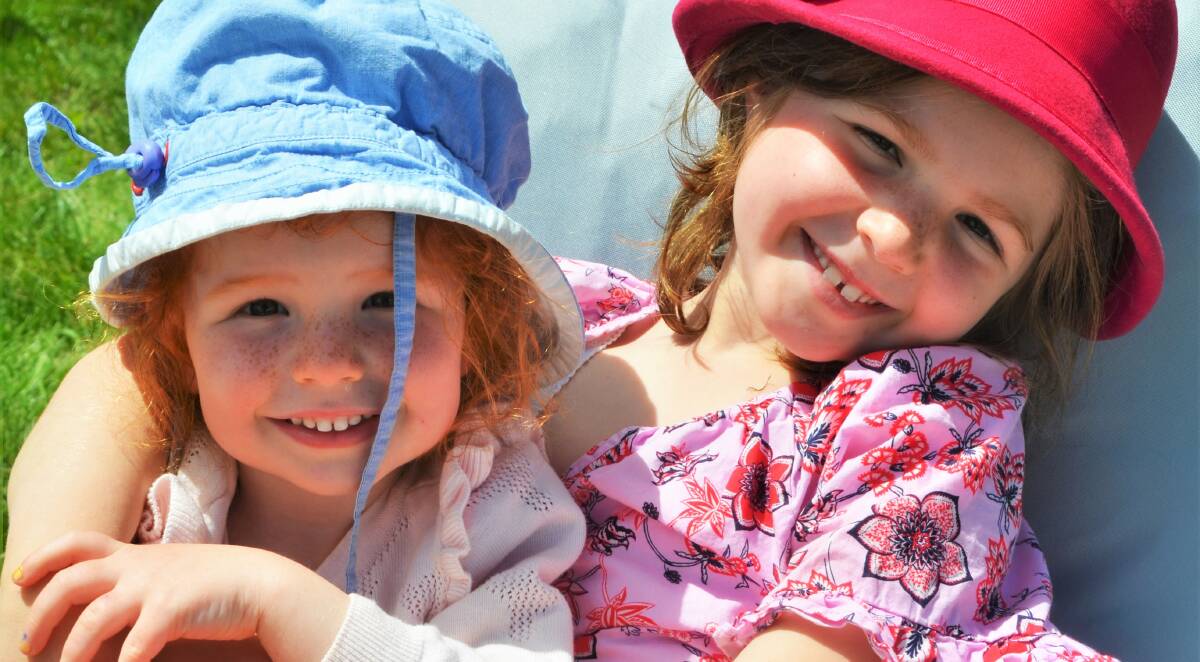 HATS ON FOR A GREAT DAY: Elsinore Workman, 3, and Evianna Workman, 6, soak up the sunshine at Josef Chromy's on Sunday. Picture: Frances Vinall 