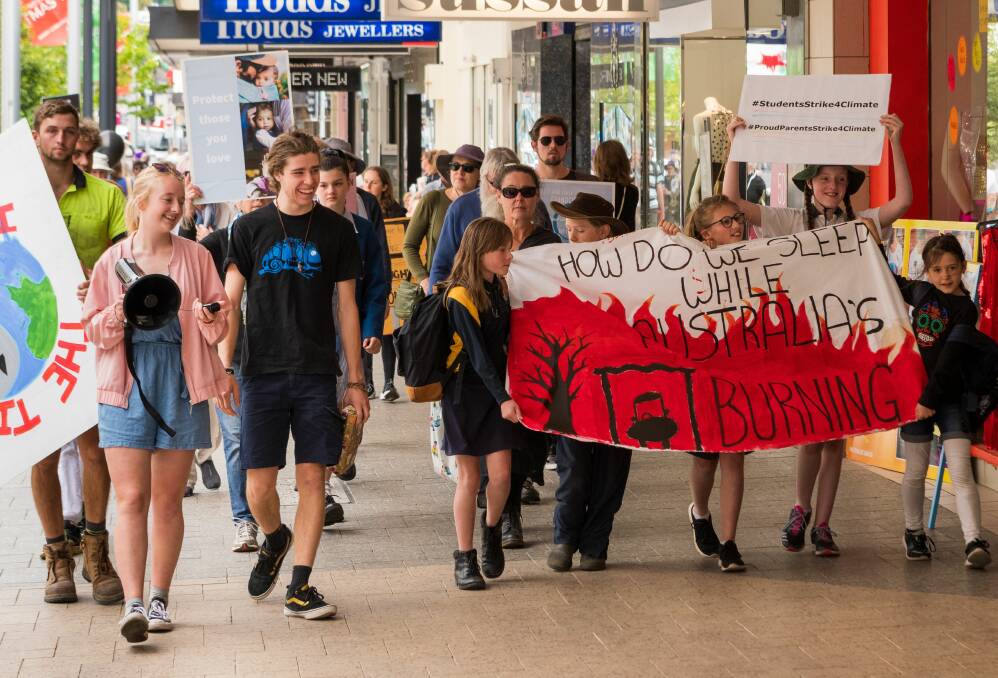 CLIMATE STRIKE: Protestors marched from the Brisbane Street Mall to Bass MHR Bridget Archer's office on Friday. Picture: Phillip Biggs 