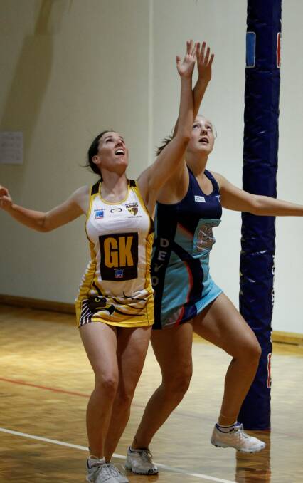 Northern Hawks' Tessa Coote and Devon's Hayley McDougall have eyes for the ball in the TNL clash in Devonport on Saturday night. Picture: Brad Cole.