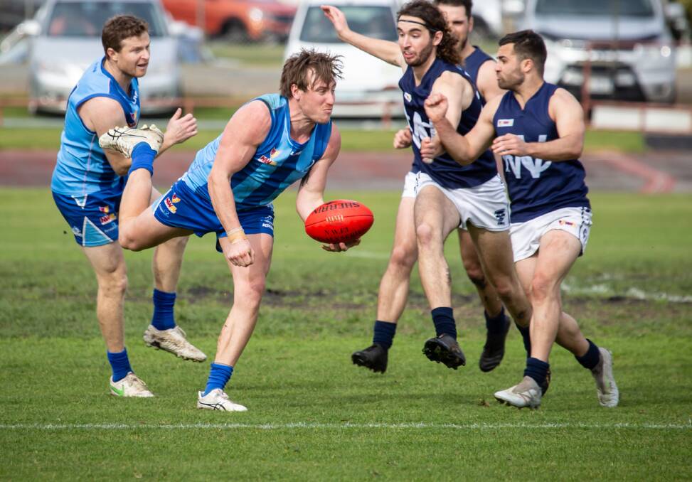 CLEARANCE: Penguin's Jayden Bramich gets a handball away during Saturday's NWFL preliminary final against Wynyard. Picture: Eve Woodhouse.