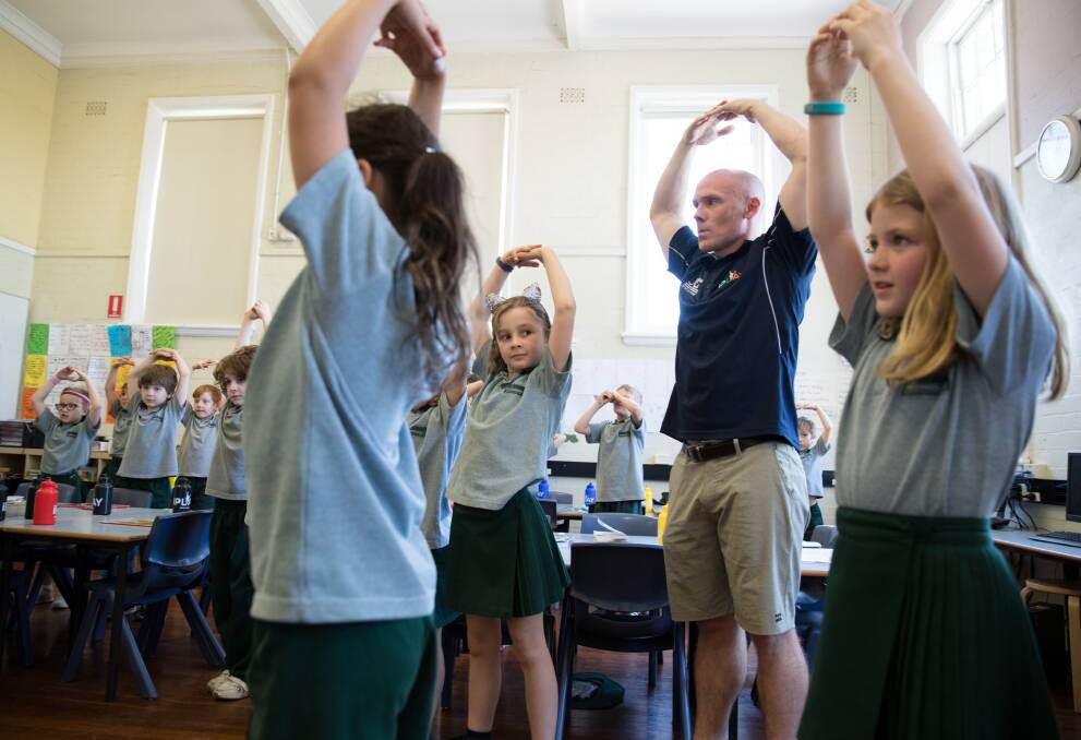 Up and about in the classroom: Professor Chris Lonsdale in a class at Sydney's Erskineville Public School, which are using his iPlay program. Photo: Janie Barrett/Fairfax Media.