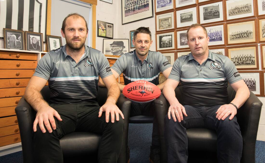 Casey Scorpions coach and former Devonport player Jade Rawlings (centre) catches up with Devonport NWFL coaches Kurt Byard (left) and Simon Dent. Picture: Matt Powell.