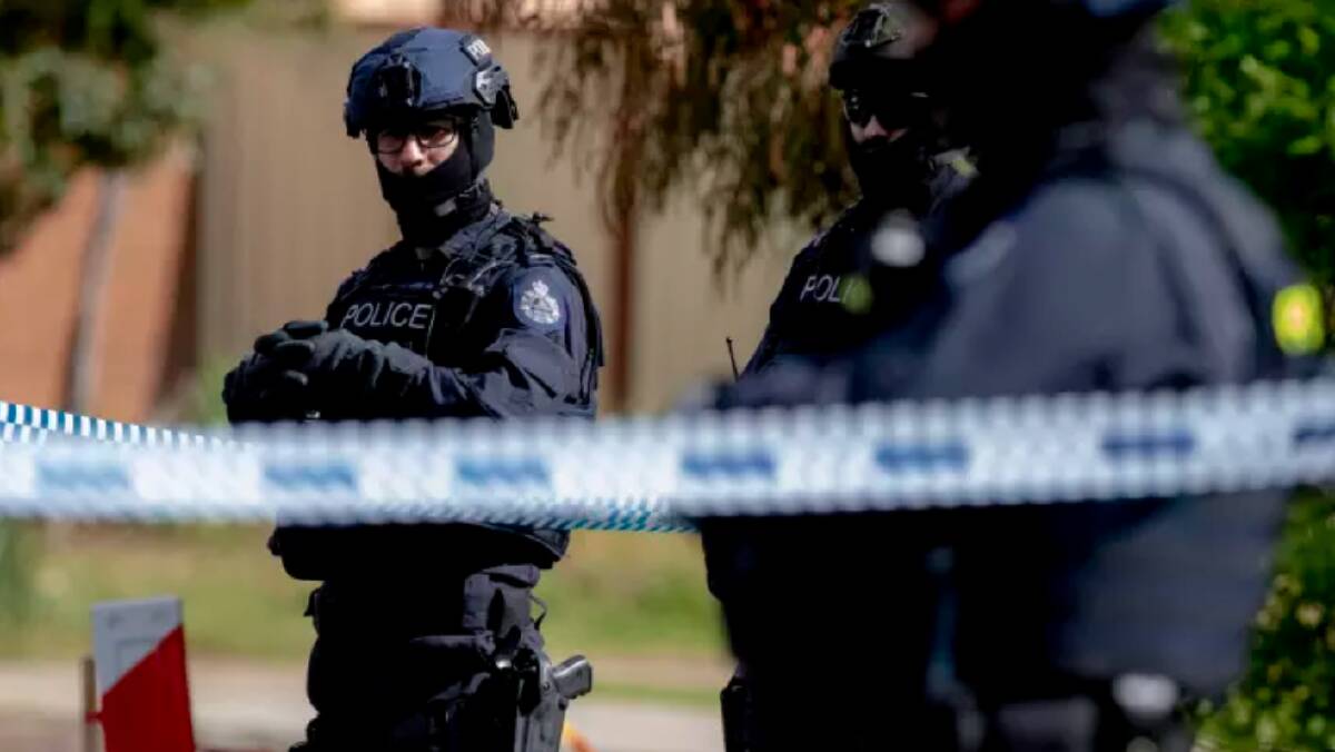 Police stand guard during a house raid in Werribee on Saturday following the Bourke Street attack. Photo: Luis Ascui 