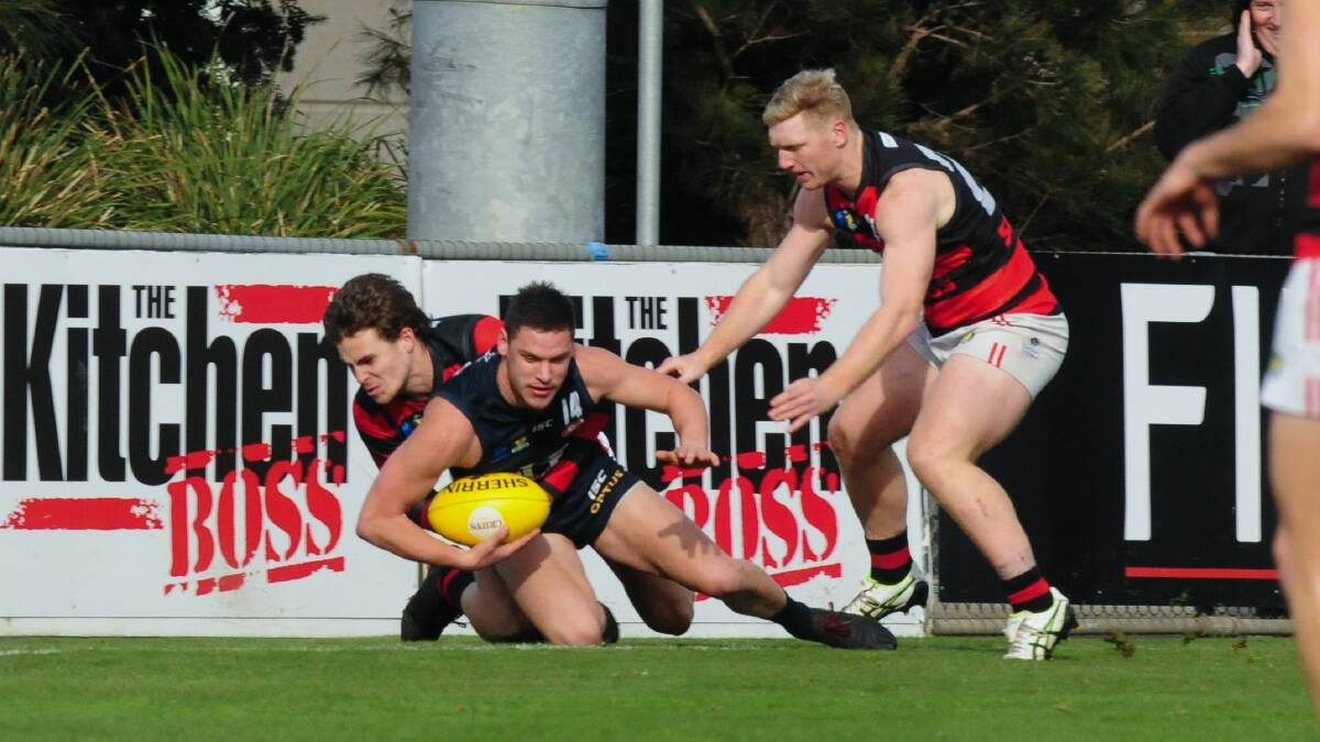 IN PURSUIT: Lauderdale skipper Bryce Walsh lends a hand as Blue Casey Brown goes down in a tackle. 