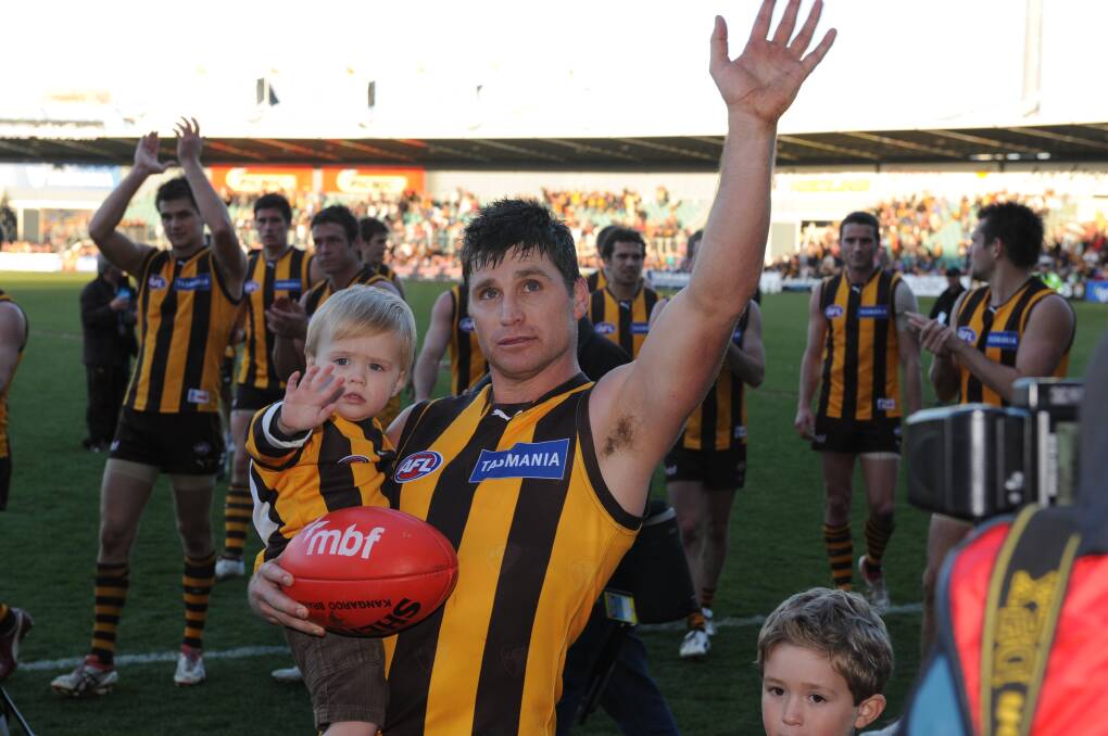 Star Hawk Shane Crawford salutes after playing his 300th game in Launceston. 