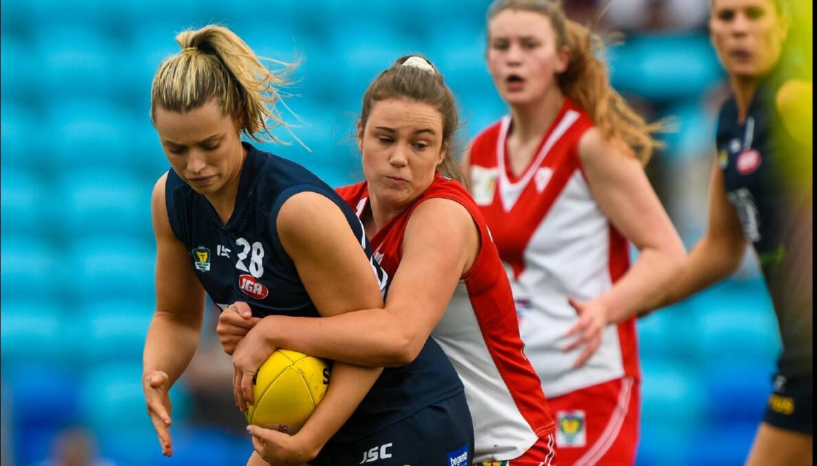 CAUGHT: Jennifer Guy gets locked up during last year's grand final loss to Clarence. Picture: Phillip Biggs