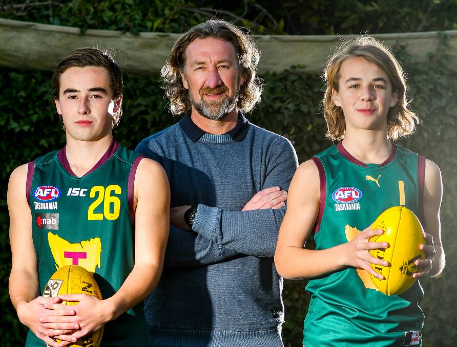 FATHERING THE FUTURE: Former Tassie Mariners coach Adam Sanders is flanked by footballing sons Oliver, 17, and Ryley, 14. Picture: Scott Gelston