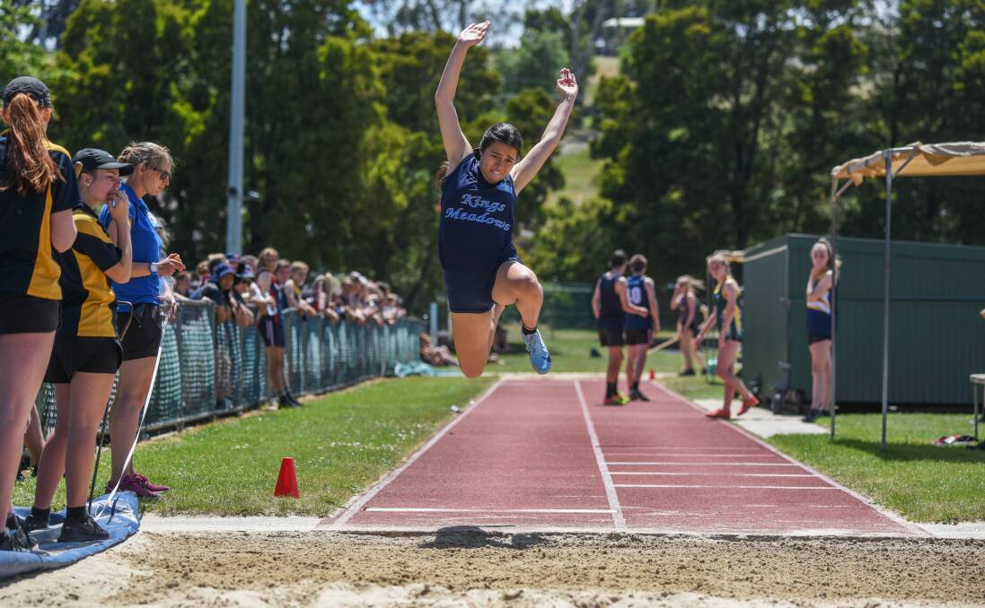 FLYING: Kings Meadows' Eliza Matthews soars through the air in the NHSSA division 1 grade 10 girls' long jump. Pictures: Paul Scambler