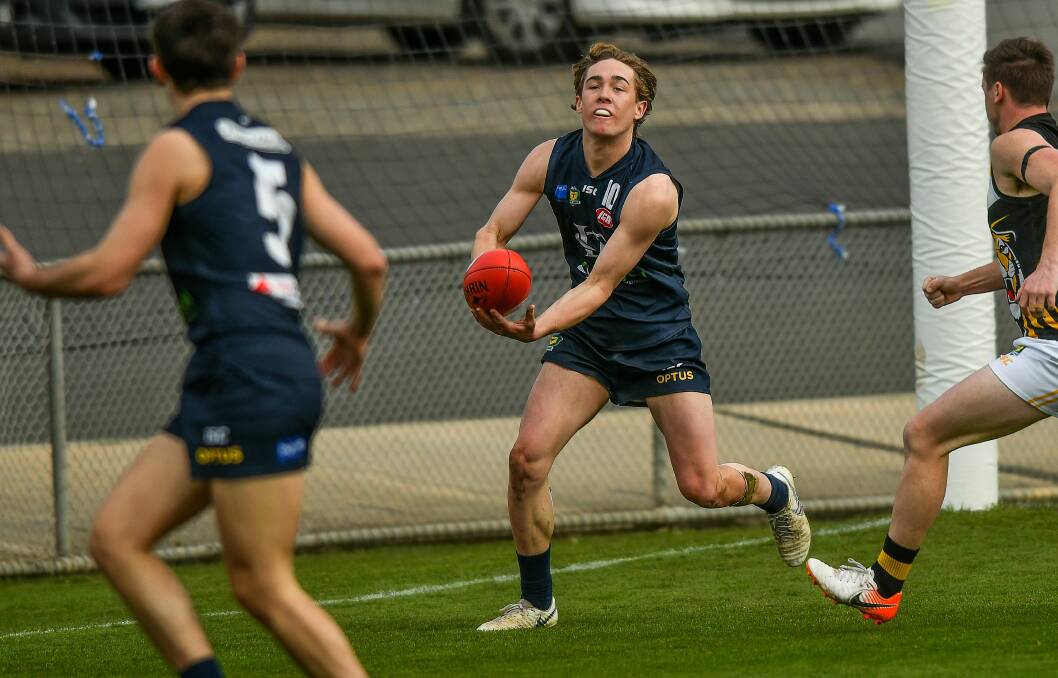 DISHING OFF: Blues defender Jacob Boyd fires off a handball to teammate Jack Tuthill. The teenage pair will both line up in Launceston's 2pm preliminary final against Lauderdale at Bellerive Oval. Picture: Scott Gelston
