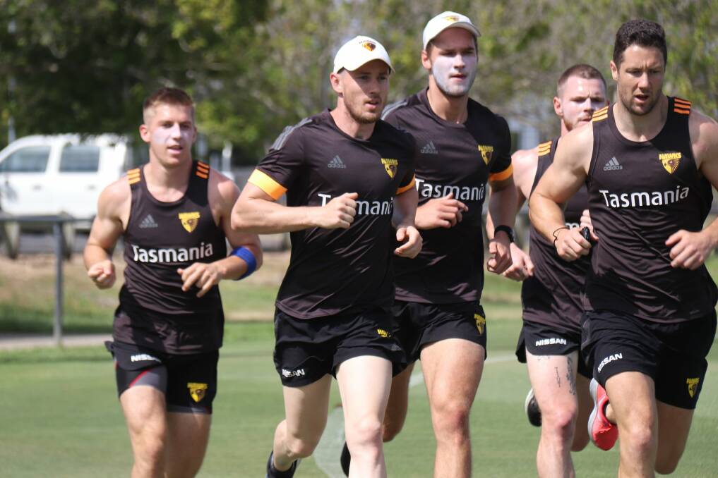 Tom Scully and James Frawley lead a pack of Hawks. 