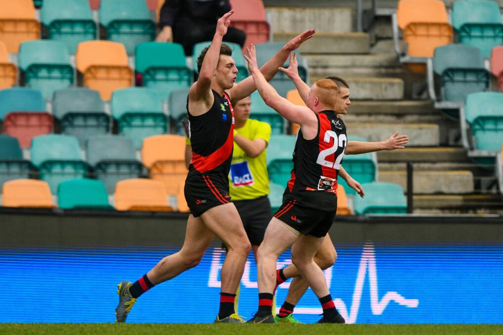 Callow celebrates a goal with teammate Jack Rushton in last year's premiership win.