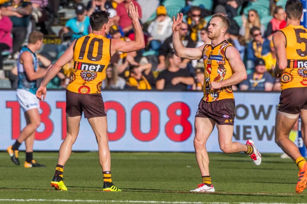 Tom Mitchell celebrates a goal with Jaeger O'Meara. Picture: Phillip Biggs