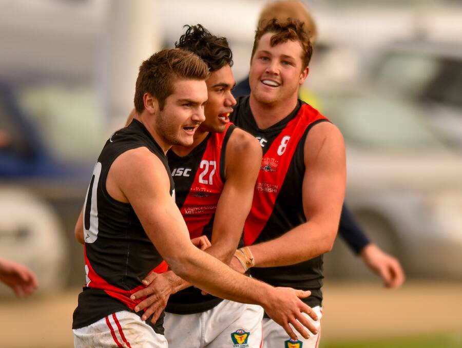 CELEBRATE: Karlton Wadley, Tarryn Thomas and Zach Burt. Wadley and Lachlan Young received late call-ups to be two of the Bombers' best.