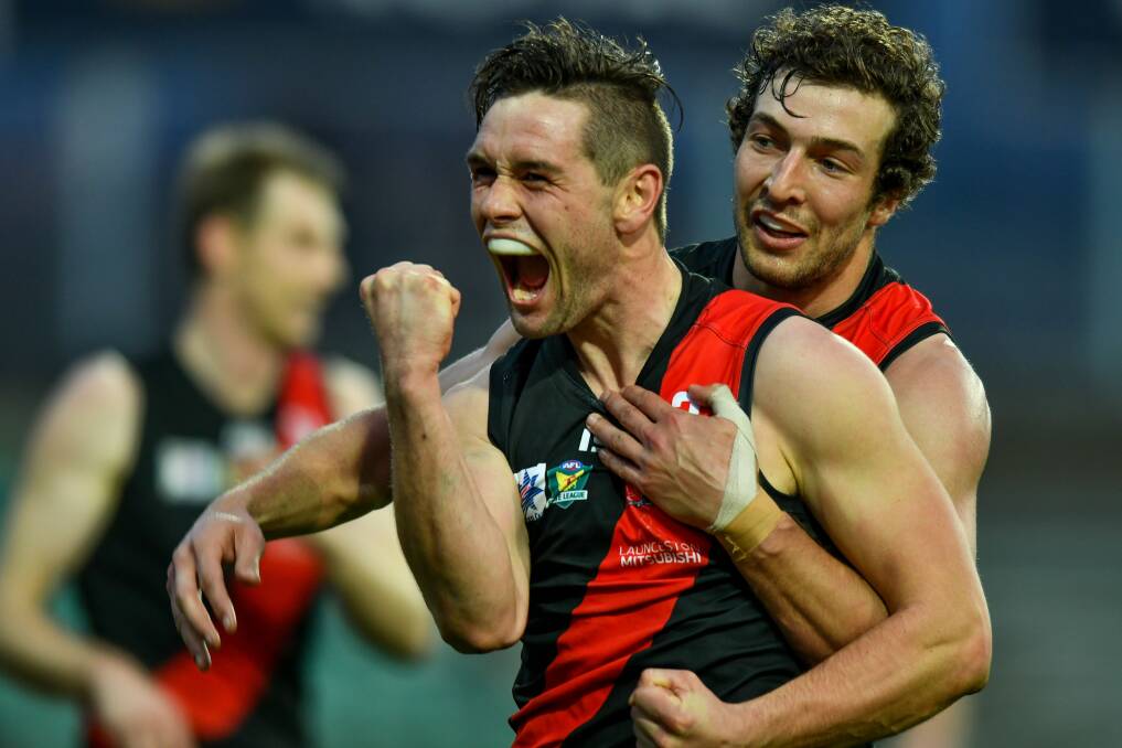 PASSION: Taylor Whitford celebrates a goal with former North Launceston teammate Tom Bennett. 