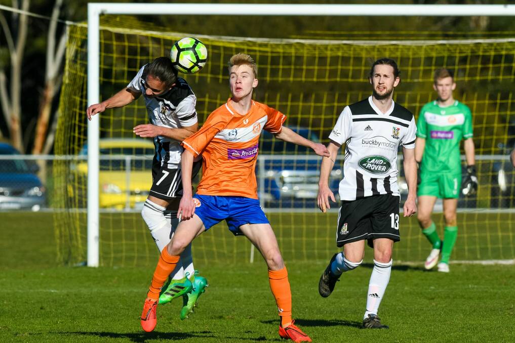 NORTHERN RIVALS: Mackenzie Hancox, of Launceston City, gets a header away from Riverside's Liam Gilmore. Picture: Phillip Biggs