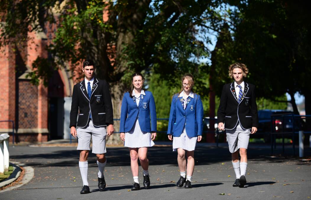 AVID AMBLERS: Grammar year 12 students Ben Barnett, Chloe Fisher, Kate Howe and Ed Loone stride out ahead of Wednesday's 80-kilometre Walkathon from Deloraine to Launceston. Picture: Paul Scambler 