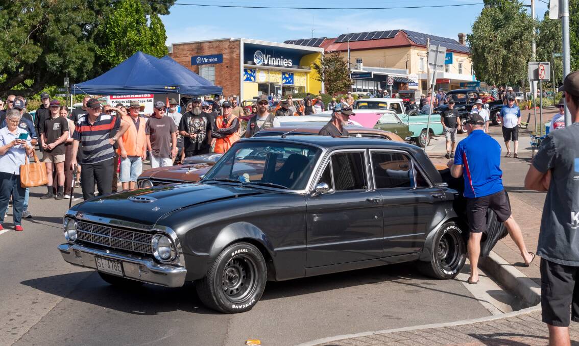 Peter Green helps take the covers off his restored 1964 Ford Falcon XM. Picture by Phillip Biggs