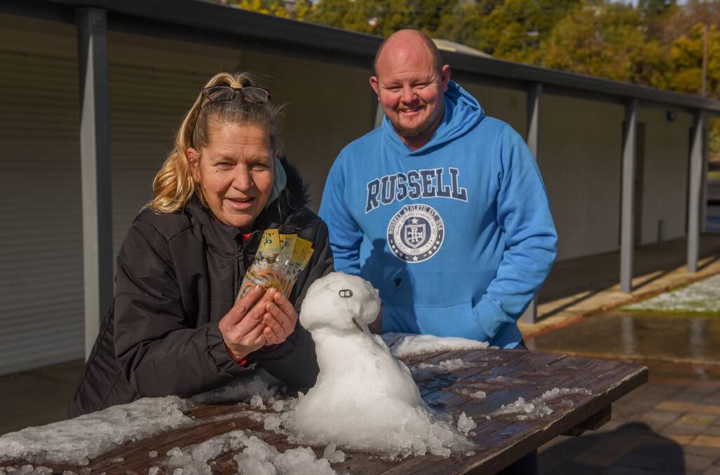 SNOWMAN IS AN ISLAND: Trevallyn Cricket Club's Charmaine Whyman and Simon Gibson with $500 raised for the Examiner's Winter appeal. Picture: Paul Scambler