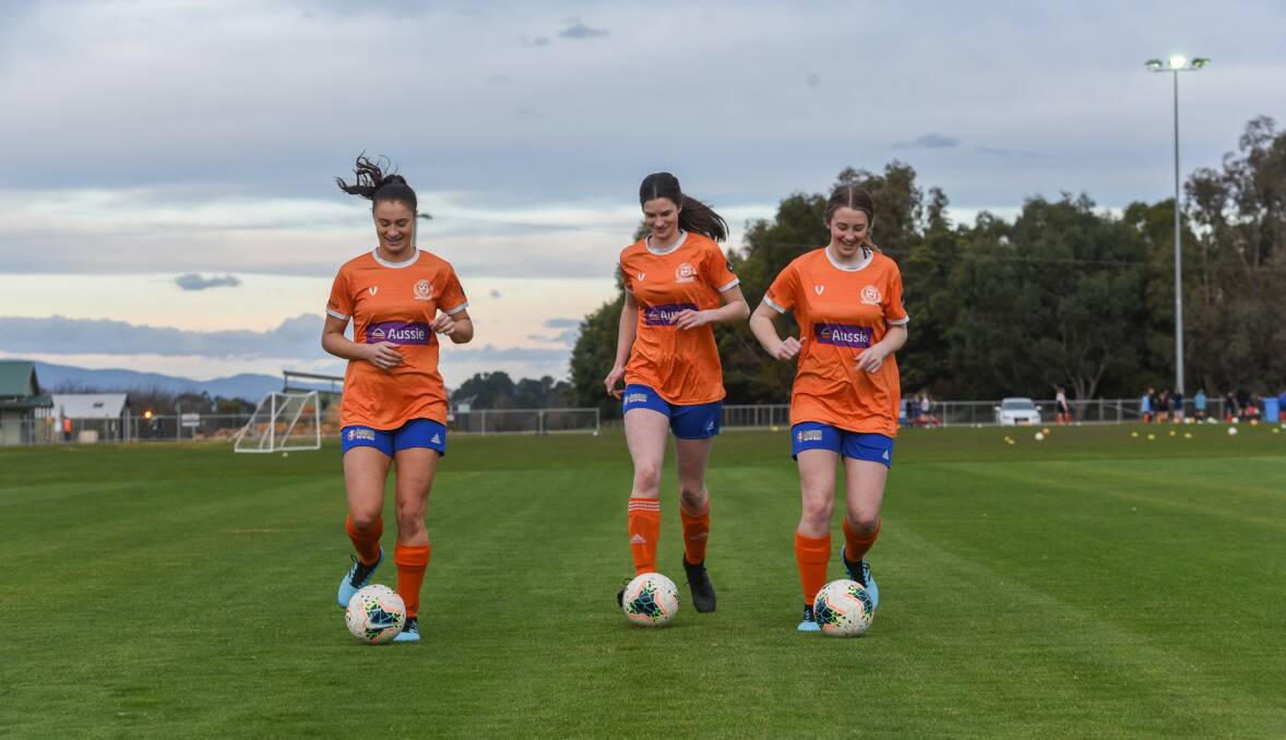 Georgia, Chelsea and Amelia dribble up the wing at Windsor Park.