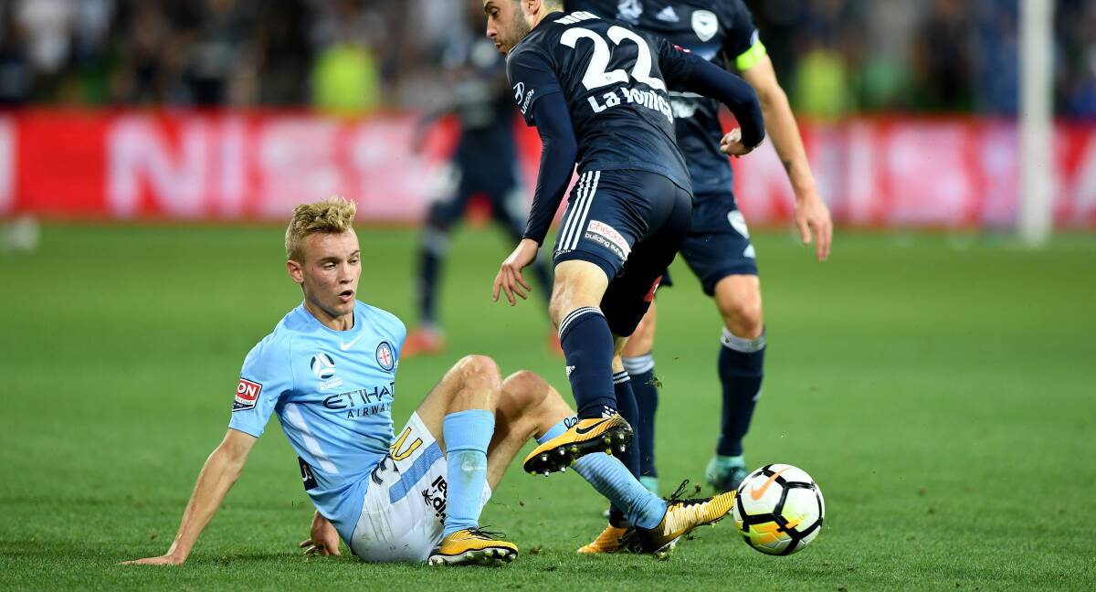 CARPET BATTLE: Nathaniel Atkinson battles for possession with Melbourne Victory's Stefan Nigro. The two sides will meet up again on Friday night. Pictures: AAP 