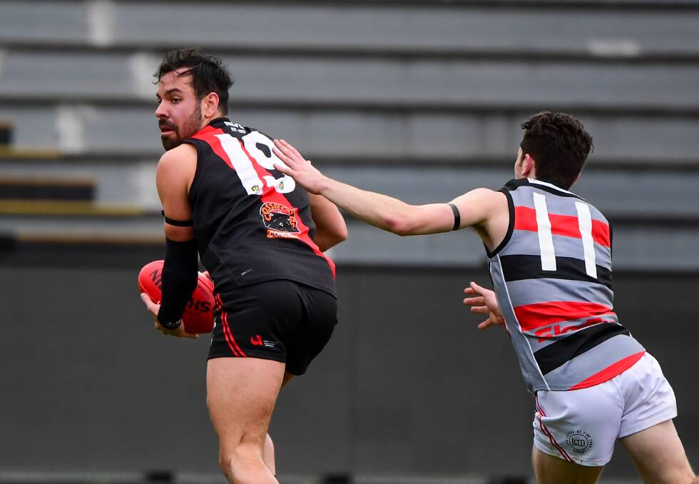 NEW STORY: North Launceston defender Braden van Buuren dashes away from Lauderdale's Luke Nelson. The 24-year-old will play his first senior grand final on Saturday. Picture: Neil Richardson
