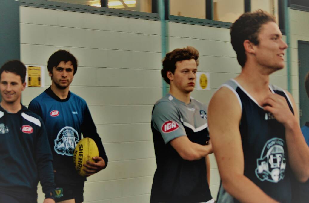 DEBUTANT: Sam Foley (centre) walks out with teammates. Picture: Hamish Geale 