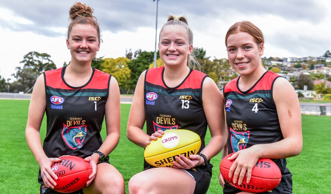 KEEN: Kelsie Hill, Ella Maurer and Mia King are busting at the seams for the Tasmania Devils girls' inaugural game on Friday. Picture: Neil Richardson