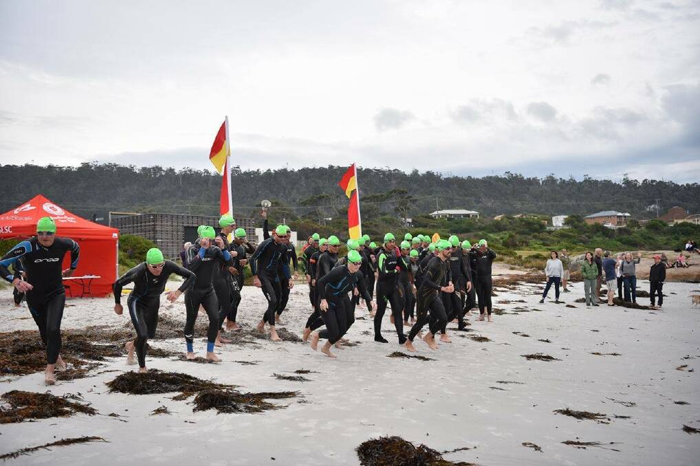 SEA SPRINT: Competitors dash to the drink in Sunday's Devil of a Swim. Picture: Saskia Sparshott