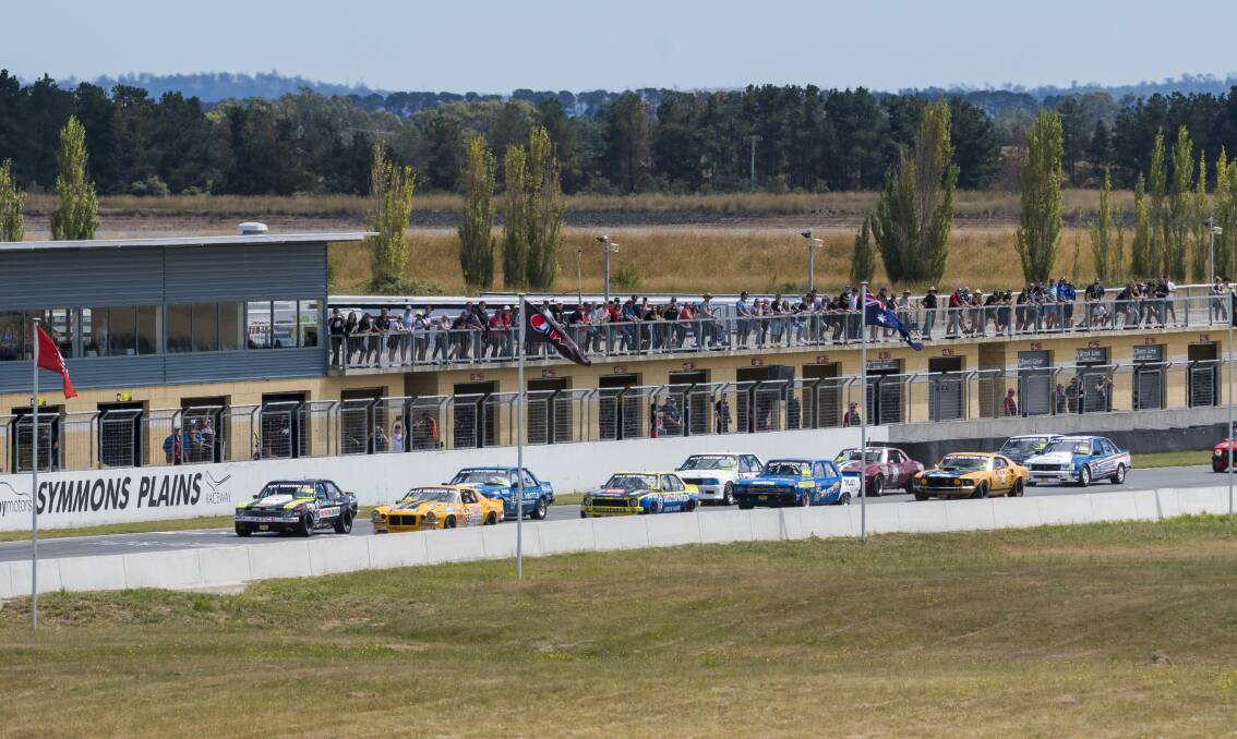 ALL IN A ROW: Fans line the first tier at Symmons Plains on Tuesday. 